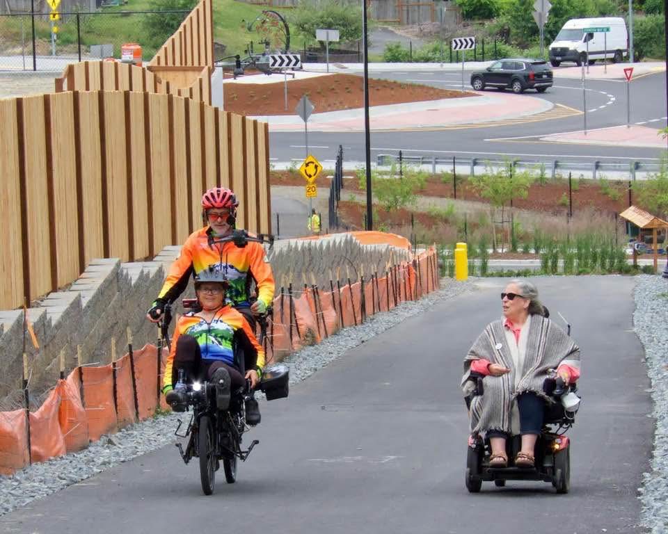 Two-person bike beside woman in wheelchair